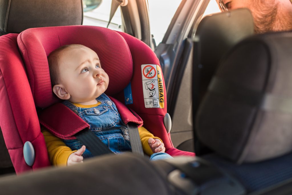 father-fasten-his-baby-in-car-seat-2023-11-27-05-16-00-utc