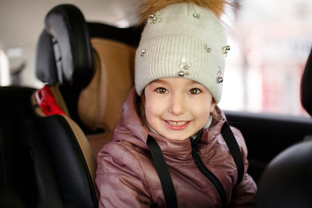 the-girl-is-sitting-in-a-child-s-car-seat-wearing-2023-11-27-05-18-02-utc